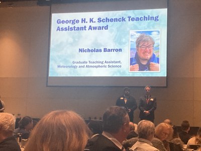 Nick Barron on stage receiving George Schenck Teaching Assistant Award