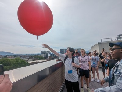 Students launching a weather balloon on the roof of Walker Building.